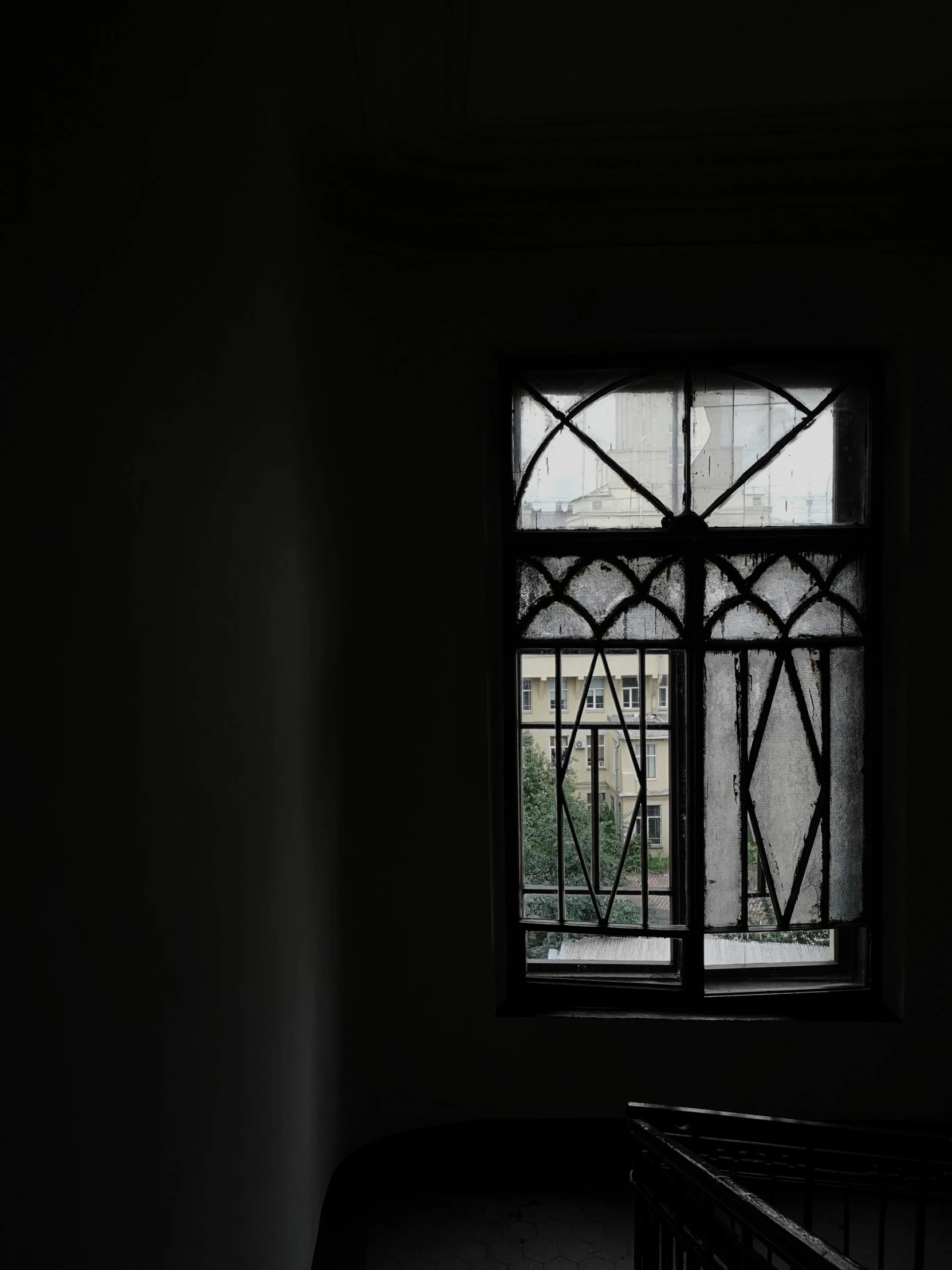 a room with a crib and window on the wall