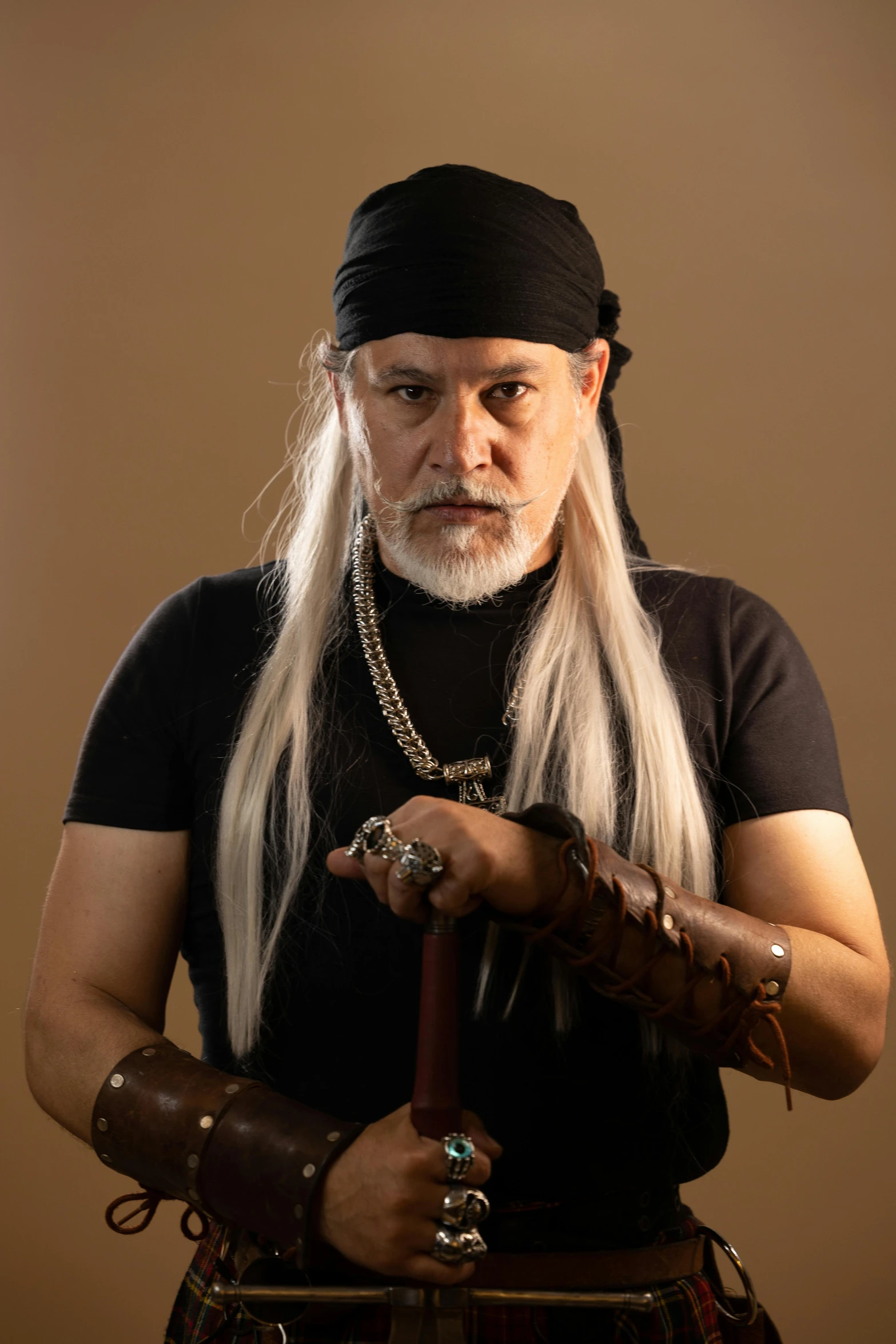 an old man with long white hair holding a cane