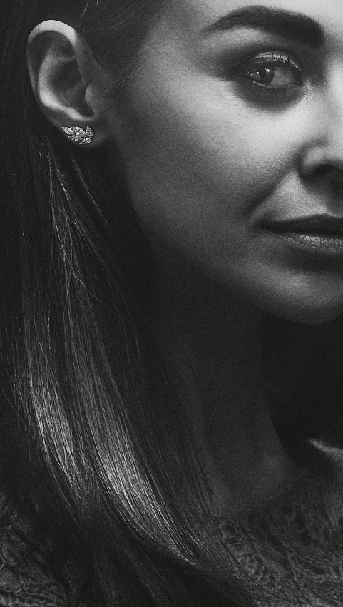 a black and white image of a woman looking off to the side