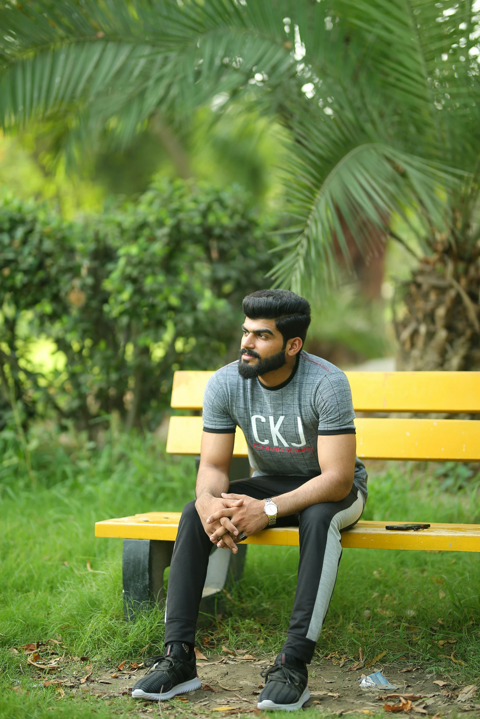 a man sitting on a bench in the park