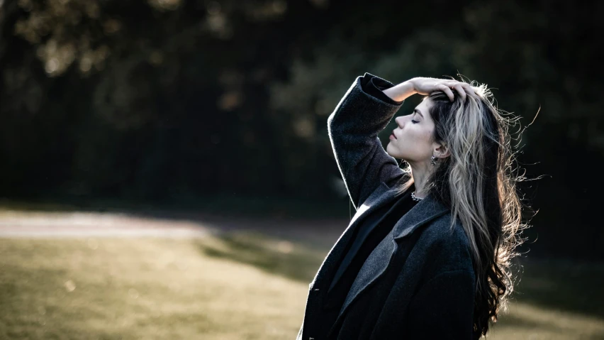 an attractive woman in a black outfit is outside