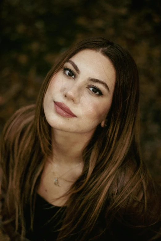 a girl smiling, in the dark with her long hair flowing