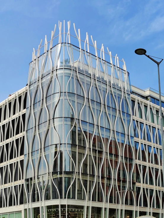 a modern glass building in front of a blue sky