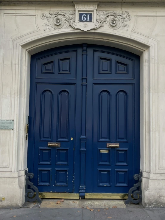 two blue doors of a building next to each other