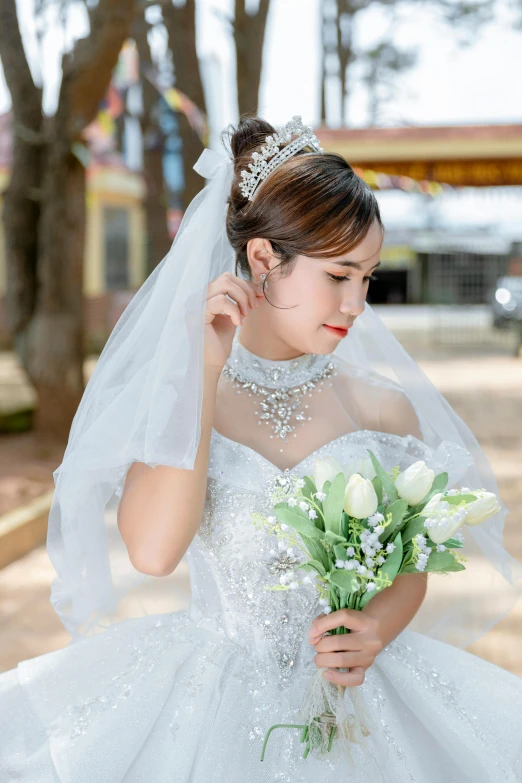 the bride in her white wedding gown holds her bouquet