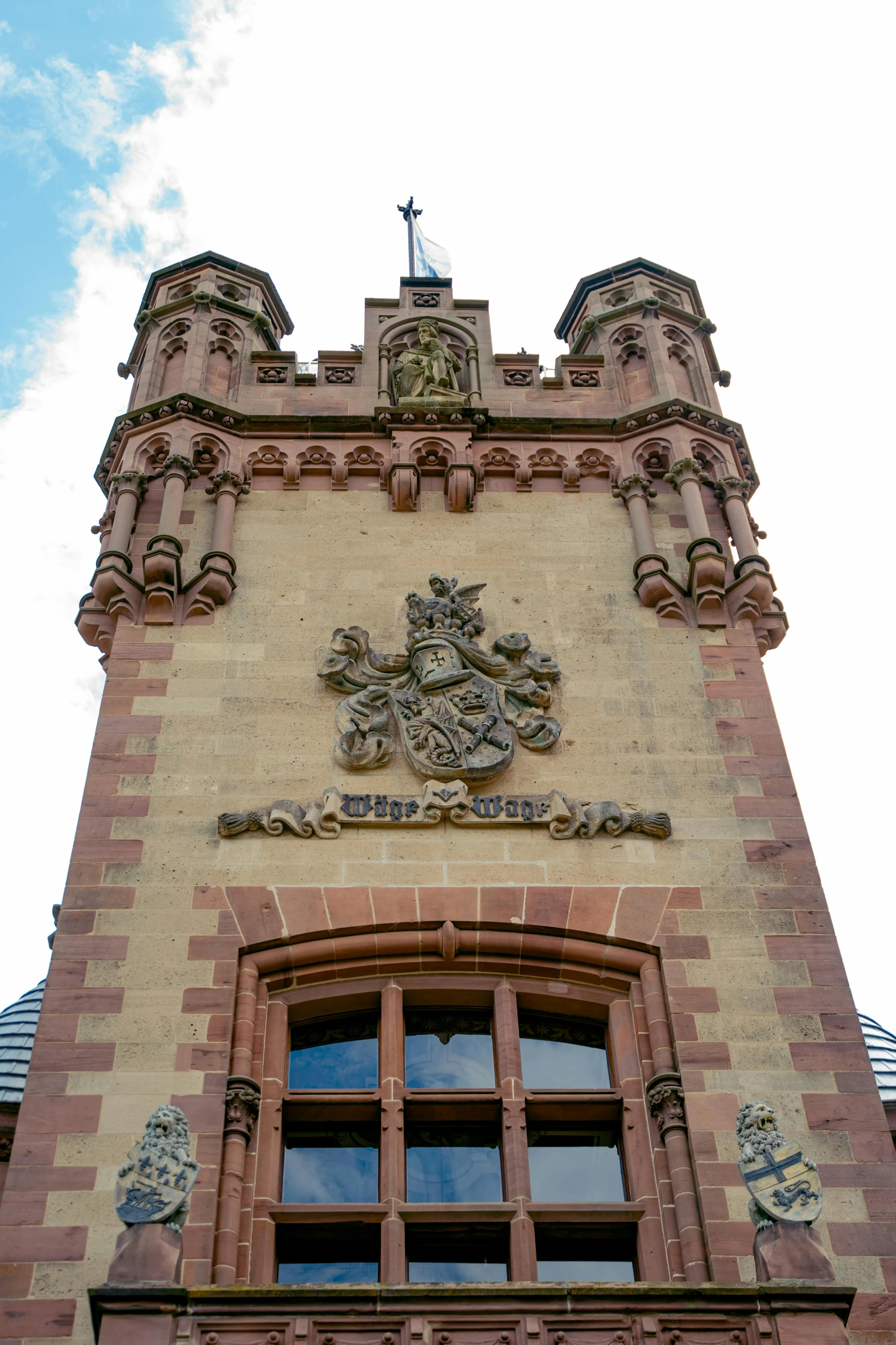 a clock on the side of a tower near a window