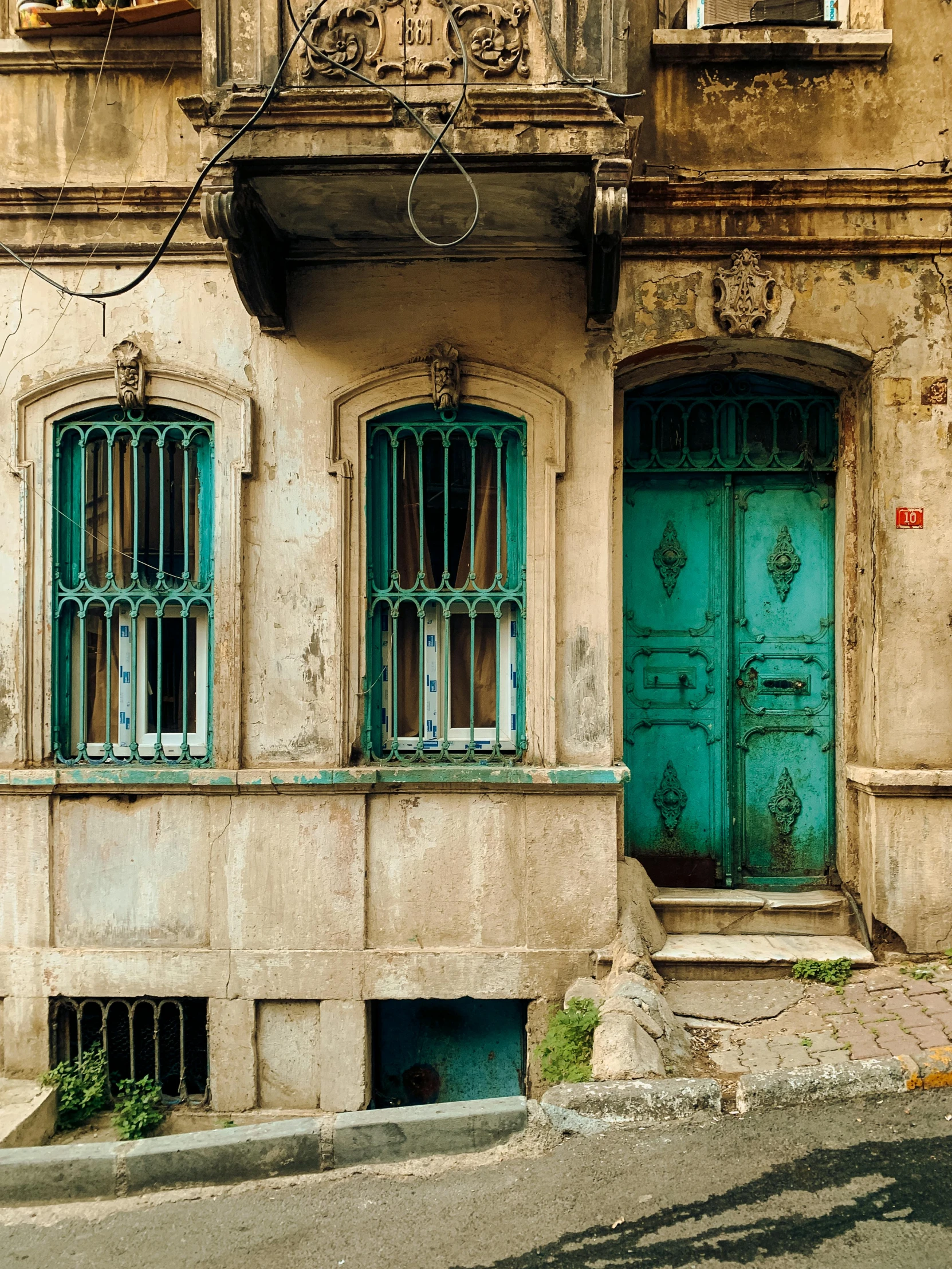 a large blue door sits on the outside of a two story old building