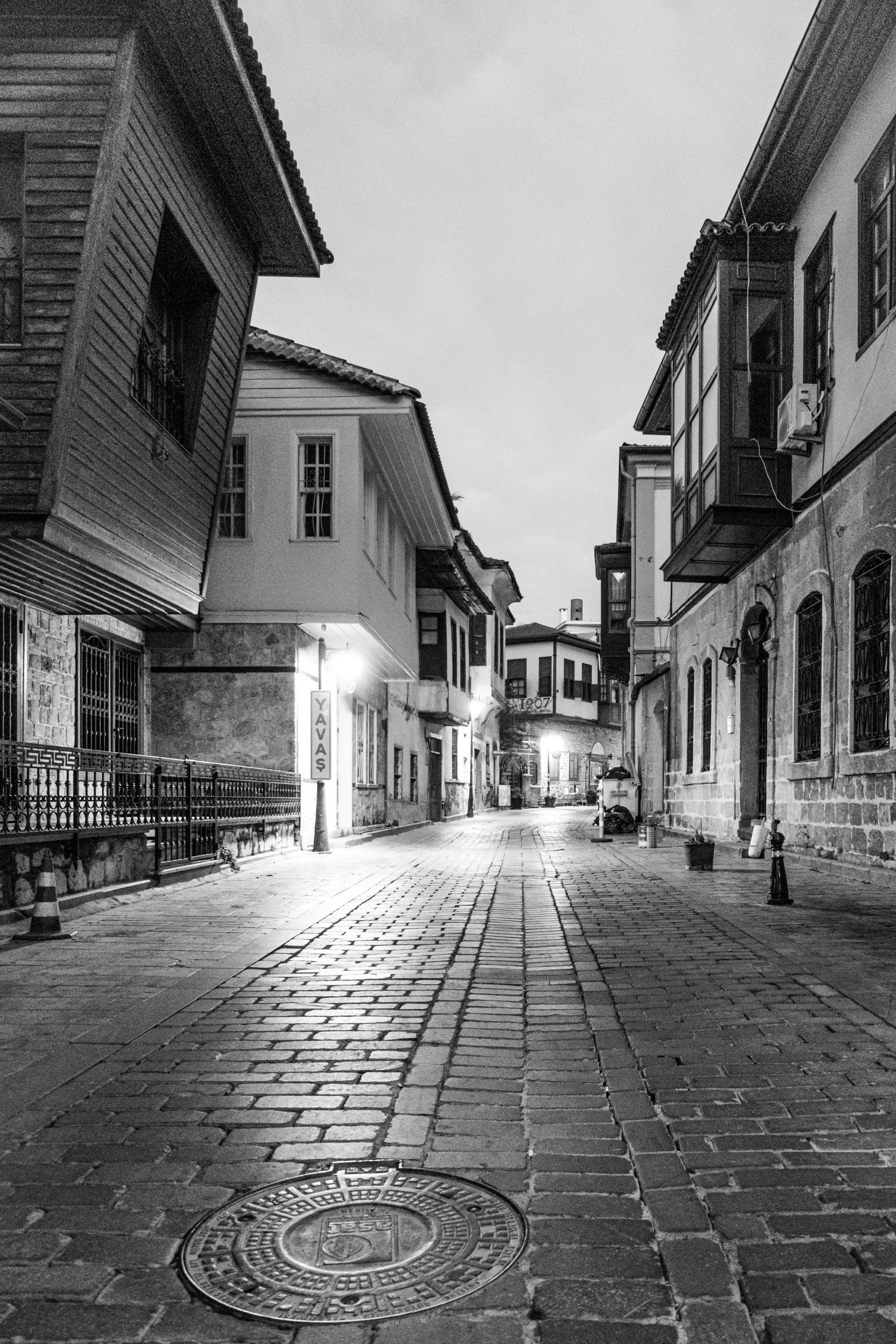 a city street with buildings and a clock