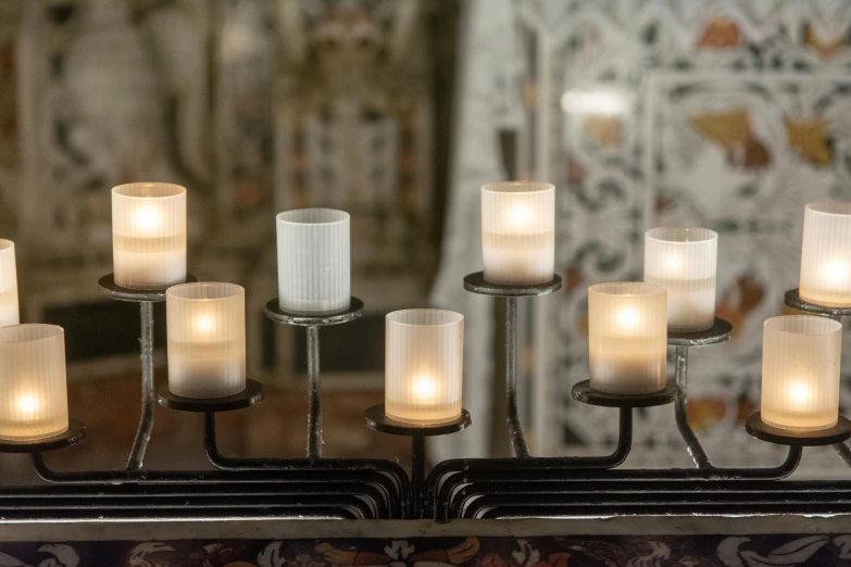 lighted candles displayed in front of the mirror in a el room