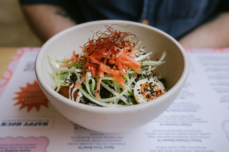 a white bowl containing an assortment of vegetables