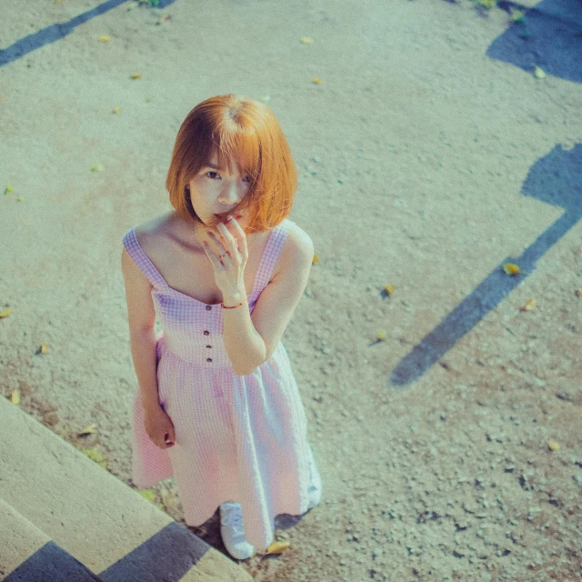 a girl in a short dress standing next to some stairs