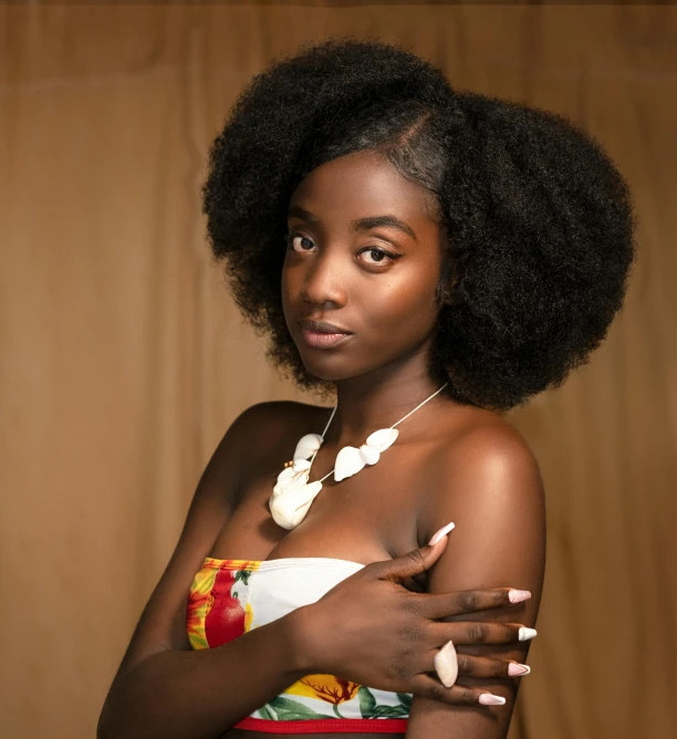 there is a young woman with an afro with necklace and arm wrapped around her