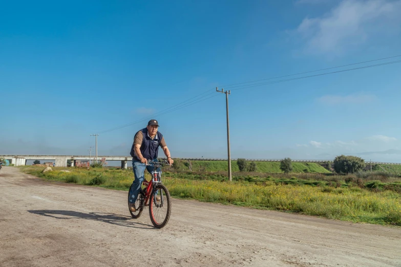 there is a man riding a bike on the dirt