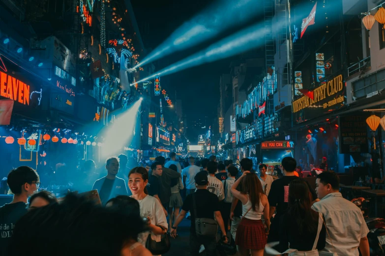 a crowd of people walking down a city street