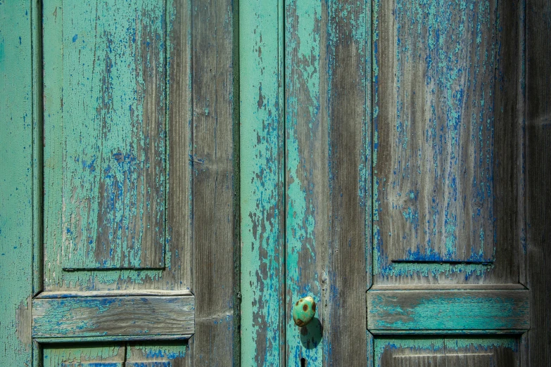 a close up of a wooden door with the door latch on it