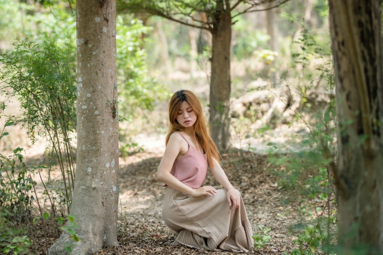 a young woman posing in a wooded area