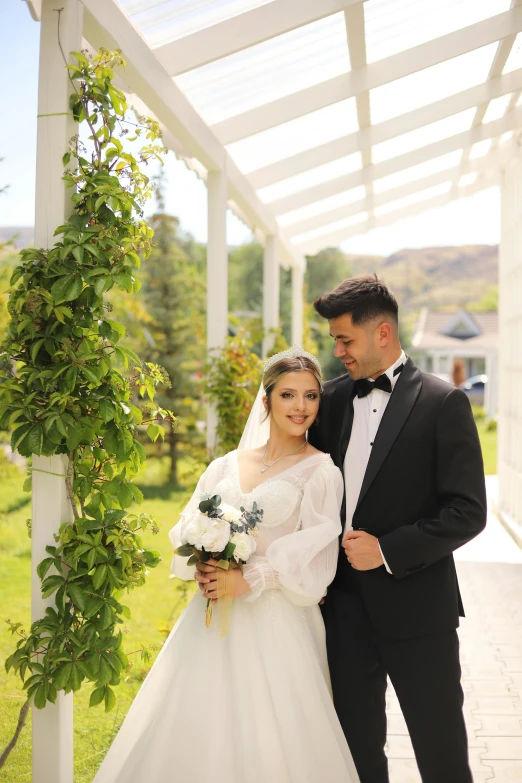 a bride and groom posing for a pograph