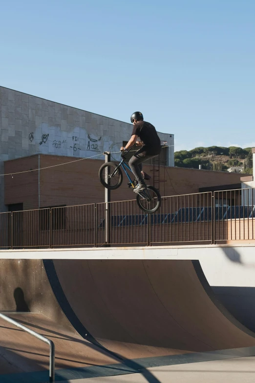 a person on a bike doing tricks in a skate park