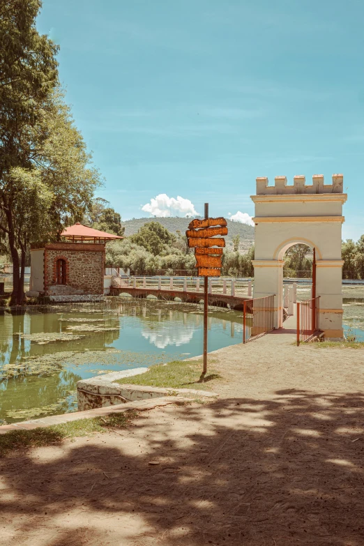 an entrance to a park that has trees on it