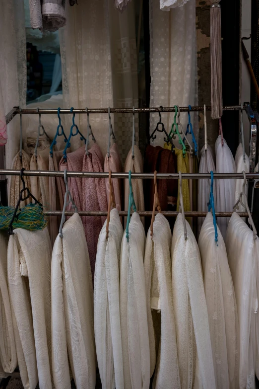 many different colored bur bags hanging on bars