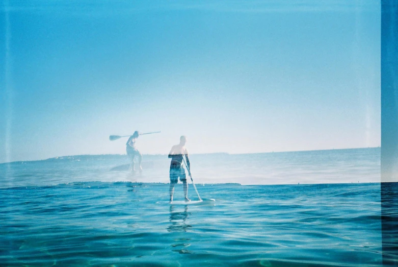 two people on surfboards in the ocean