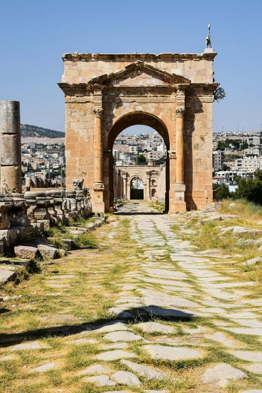 a tall archway sitting next to the side of a city