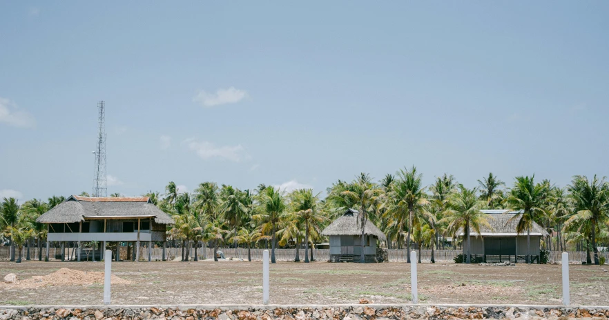 a beach house next to a beach near the ocean