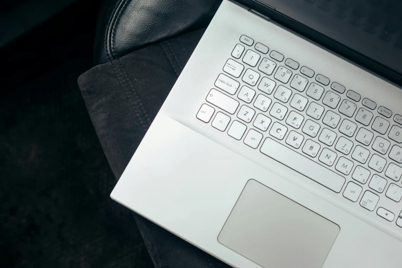 an open laptop computer on a leather chair