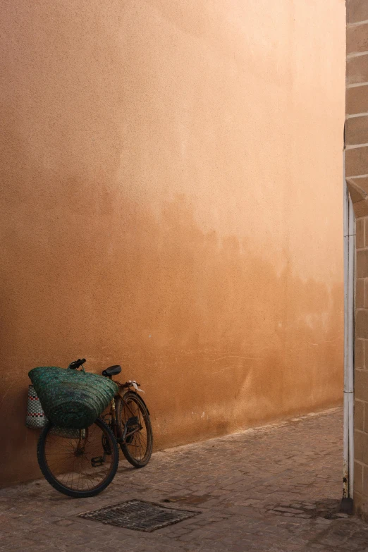 a bike locked to the wall of a building