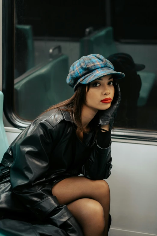 girl with red lips in hat and black leather jacket