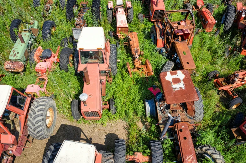 an aerial view of tractors and farm equipment parked at a roadside fair
