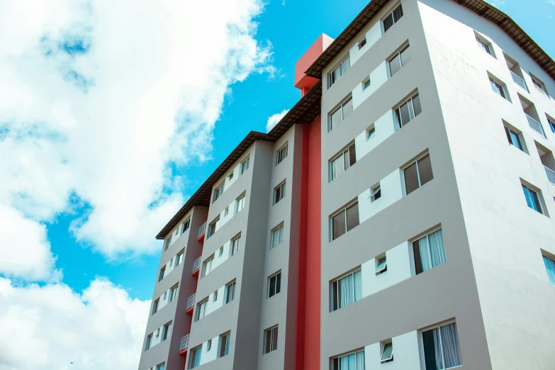 a building is tall with some windows and sky in the background