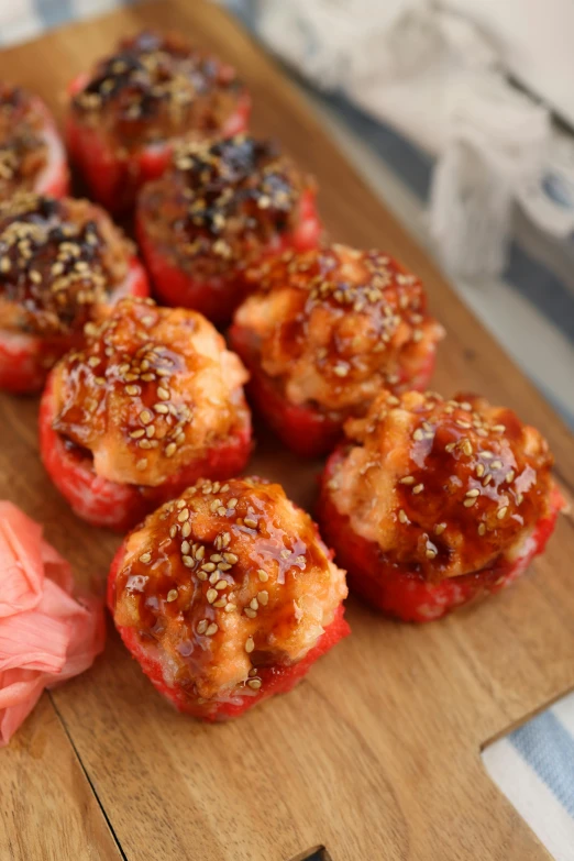 some red peppers on a  board with black sesame seeds