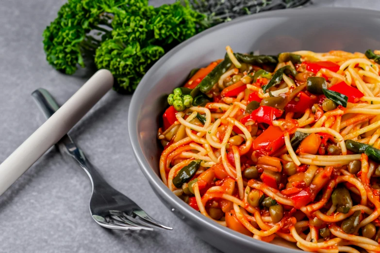 a metal bowl with some noodles in it