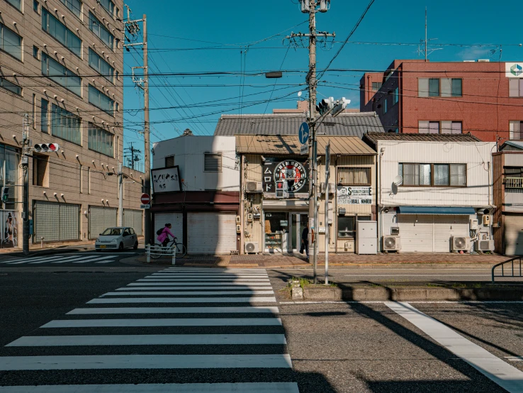 an empty street with tall buildings and street signs