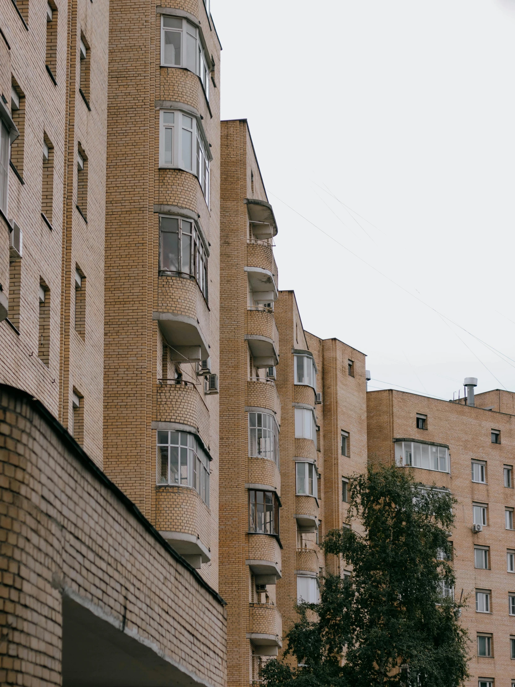 tall brick buildings and a street light in front of them