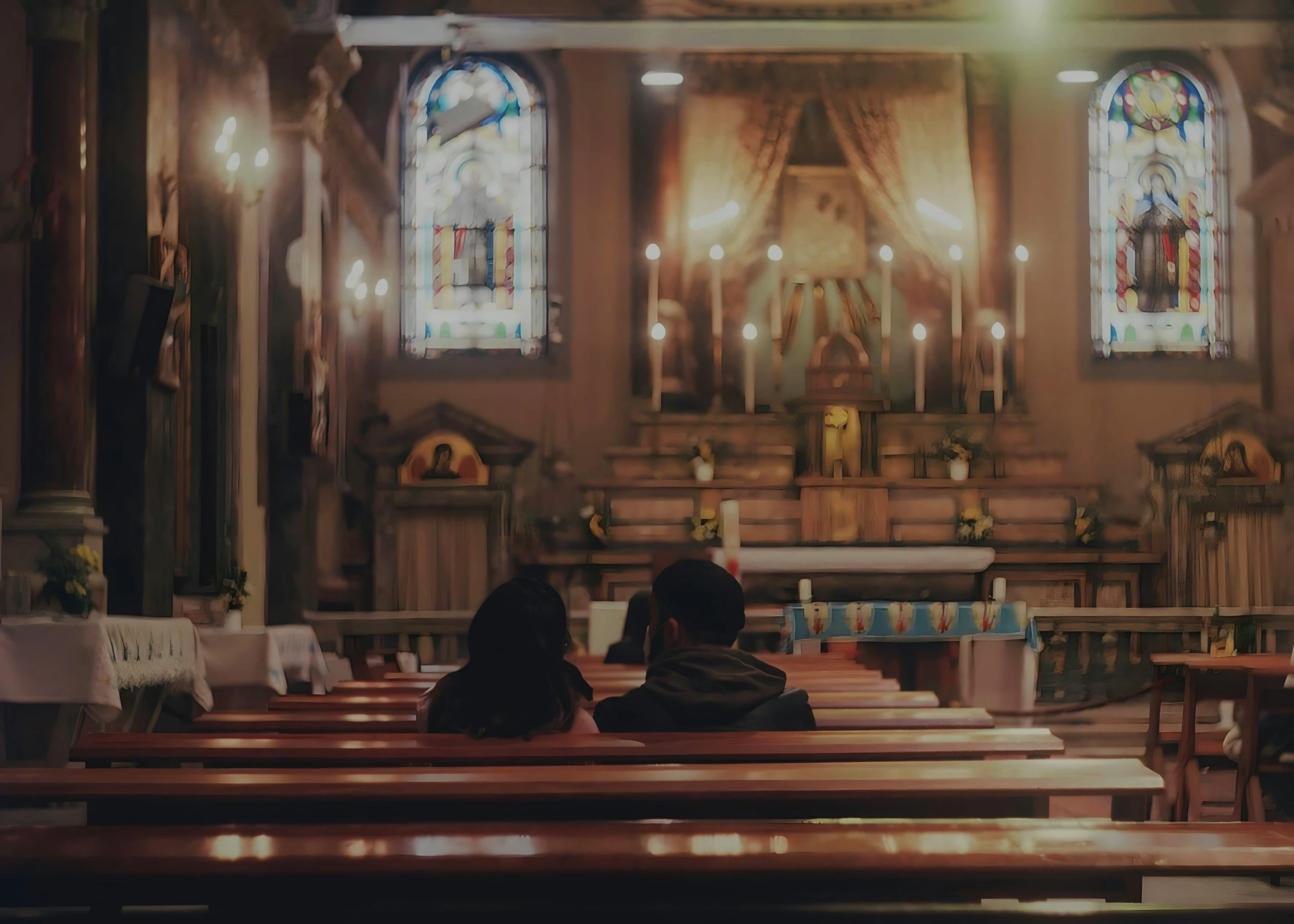 two people sitting in pews at a church