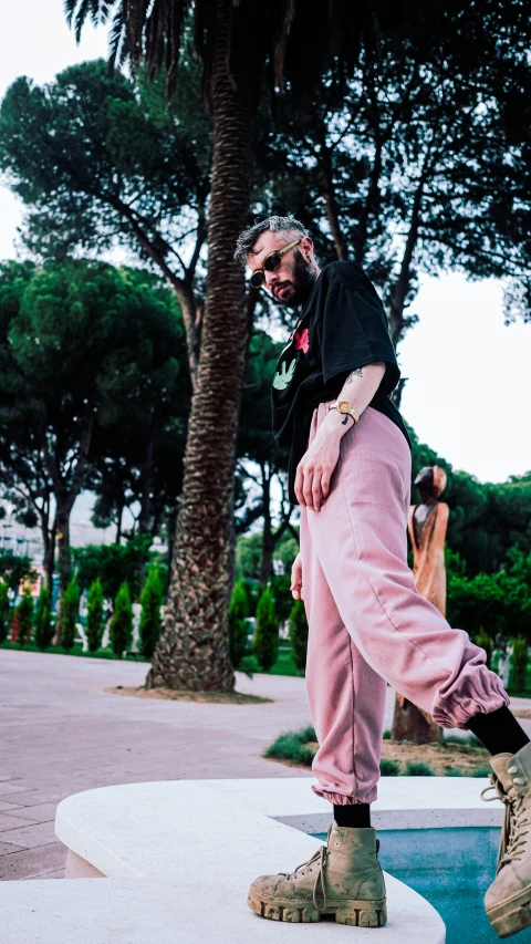 a man in pink pants is on a skateboard