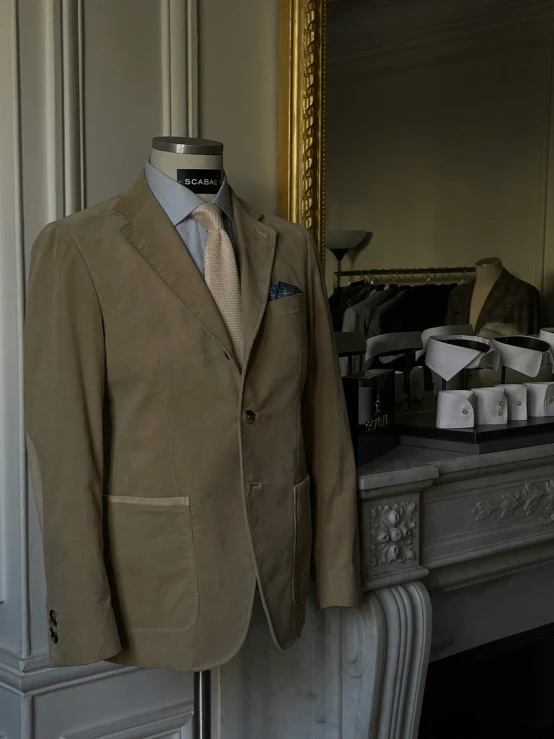 a suit and tie hang on a dress mannequin