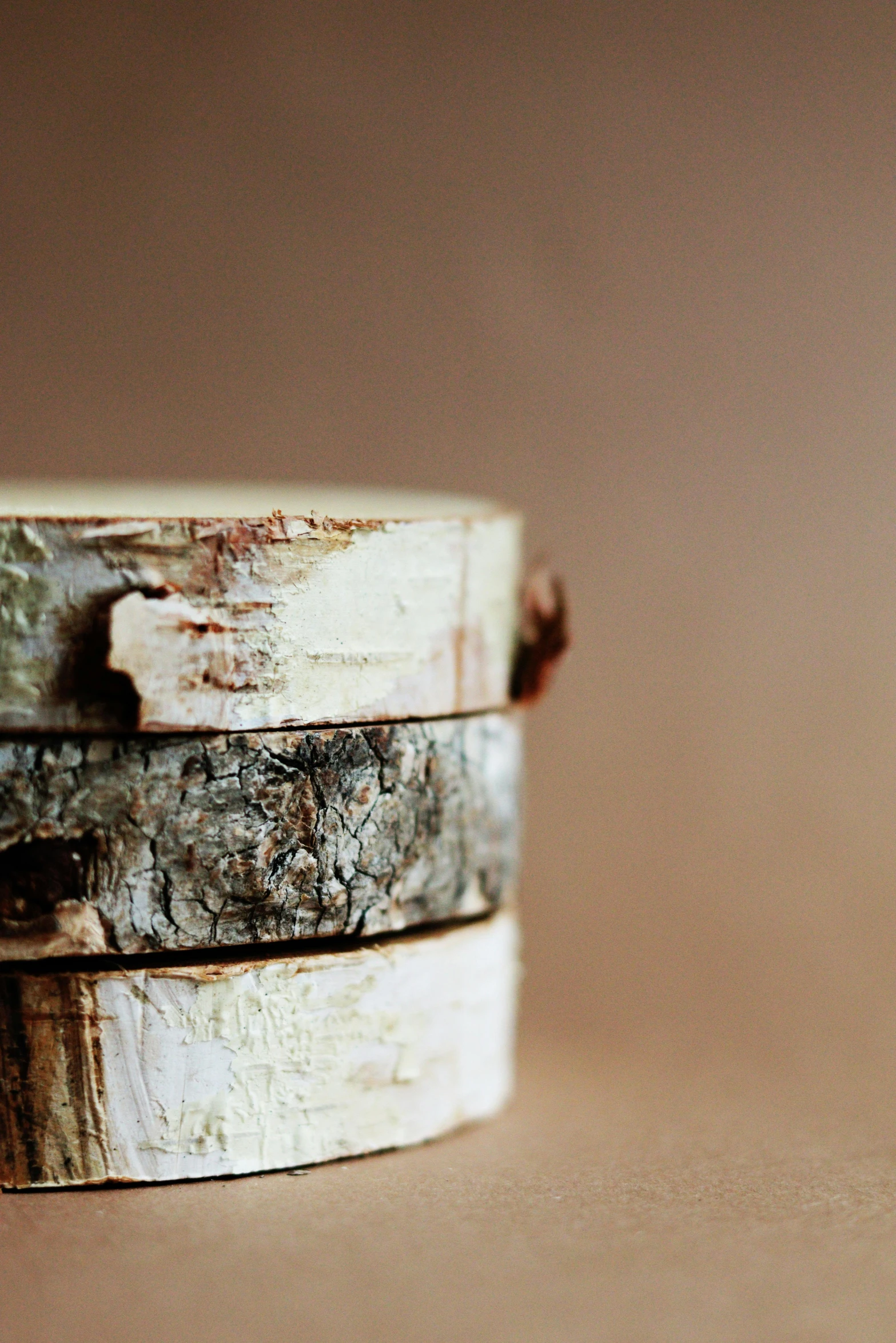 three small wooden rings with different colored wood beads