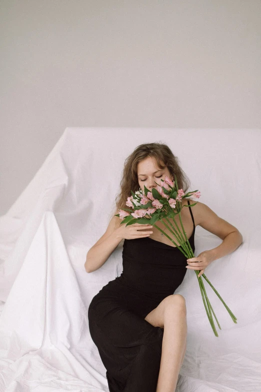 a woman laying on top of a bed with flowers