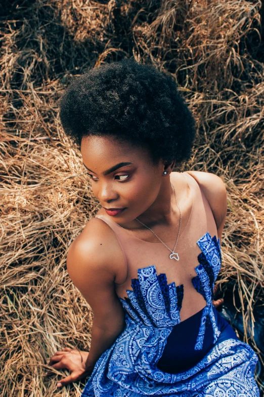 young woman sitting on the ground posing for picture