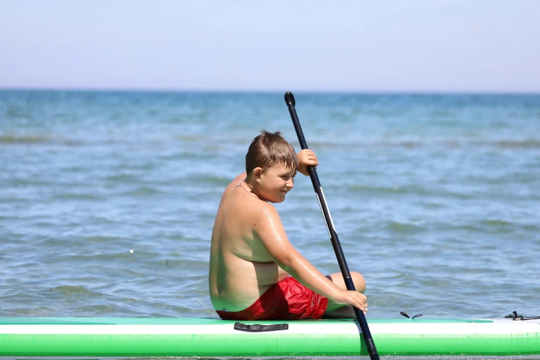 a  holding a paddle boat while paddling on the water