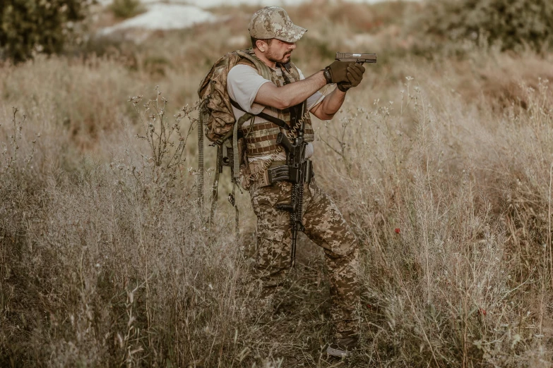 a man is standing in a field holding an object