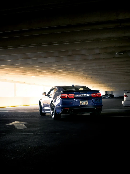 there is a car that is parked under the bridge