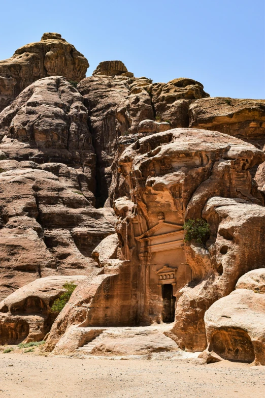 the entrance to a cave in the side of a mountain