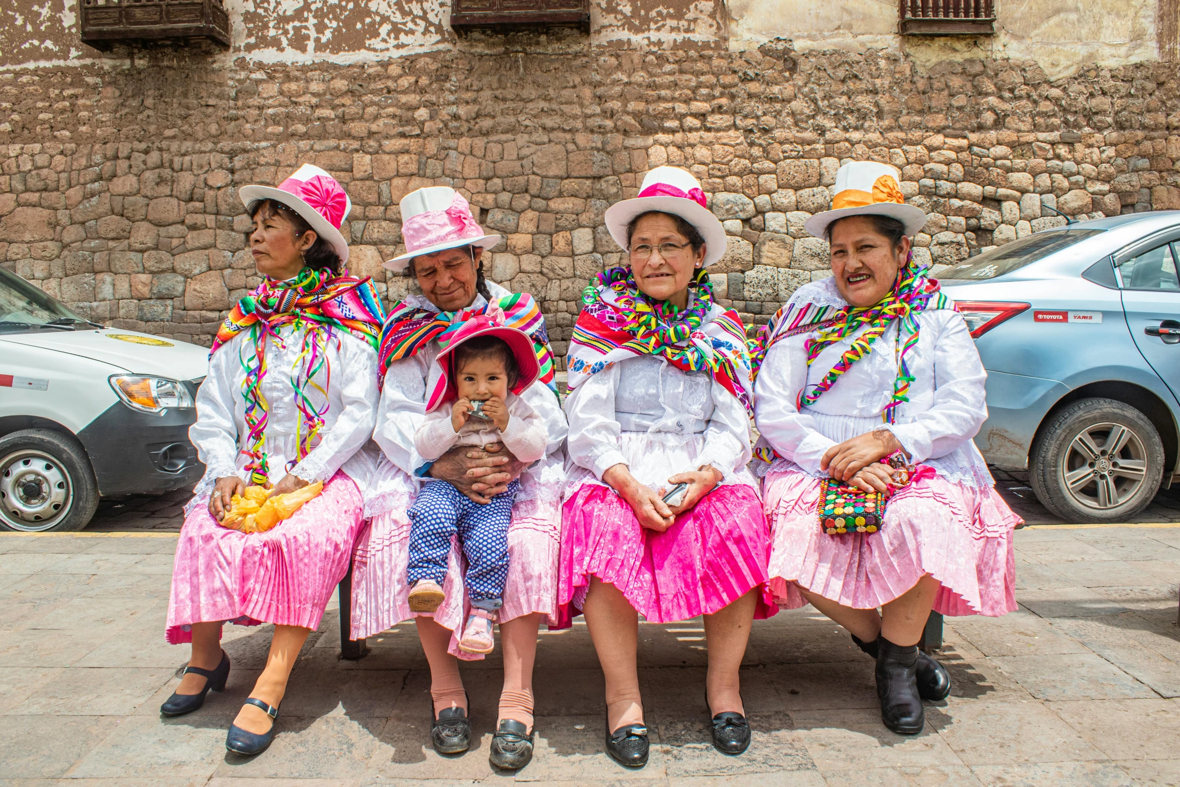 three women and their child pose for a pograph while in costume