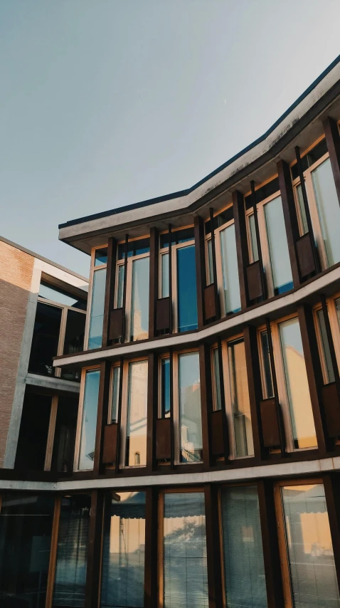 a modern building with windows reflecting in the sun