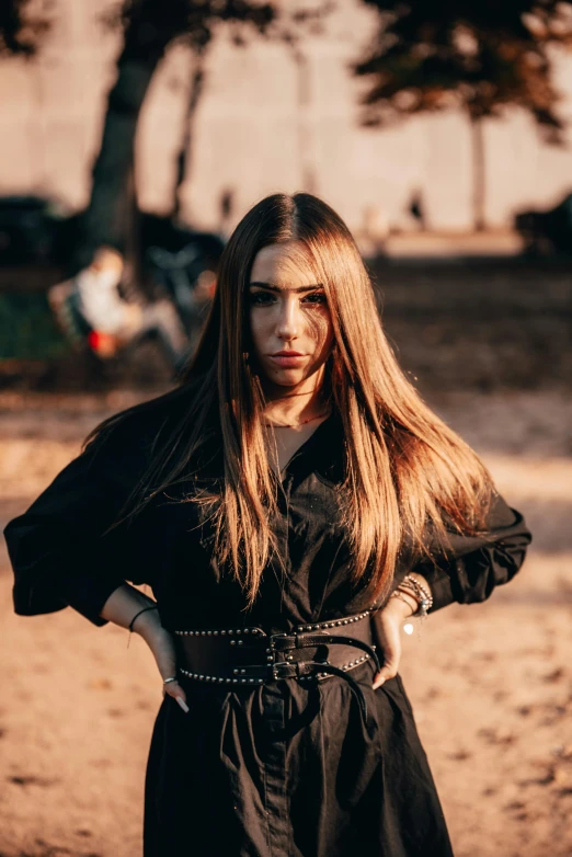 a woman with long brown hair is dressed in black