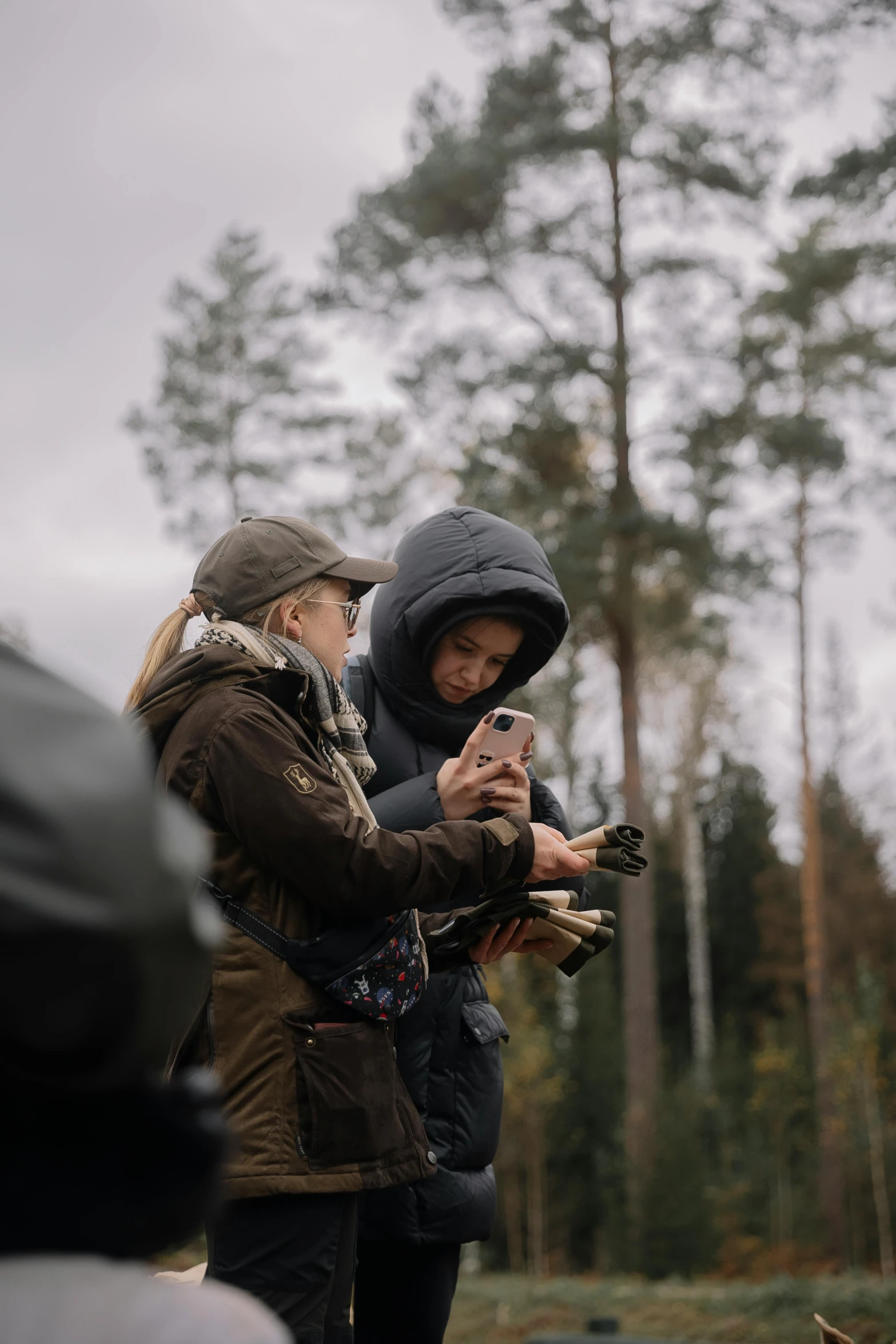 two women looking at the same cell phone